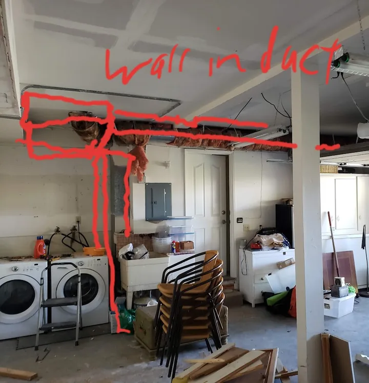Garage before finishing, with exposed ceiling ductwork, unfinished seams, and the original red annotation.