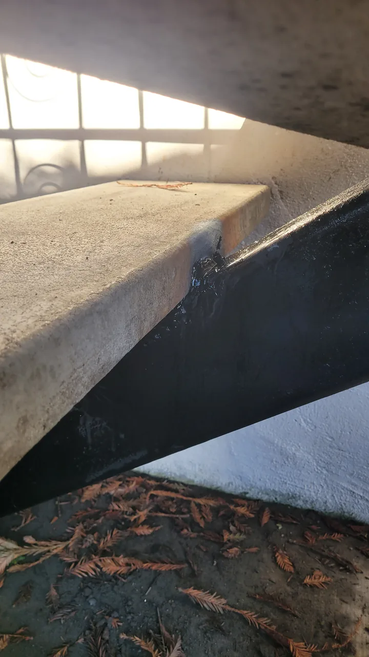 Close-up of the replaced tread repair, black-coated steel, and upper joint.